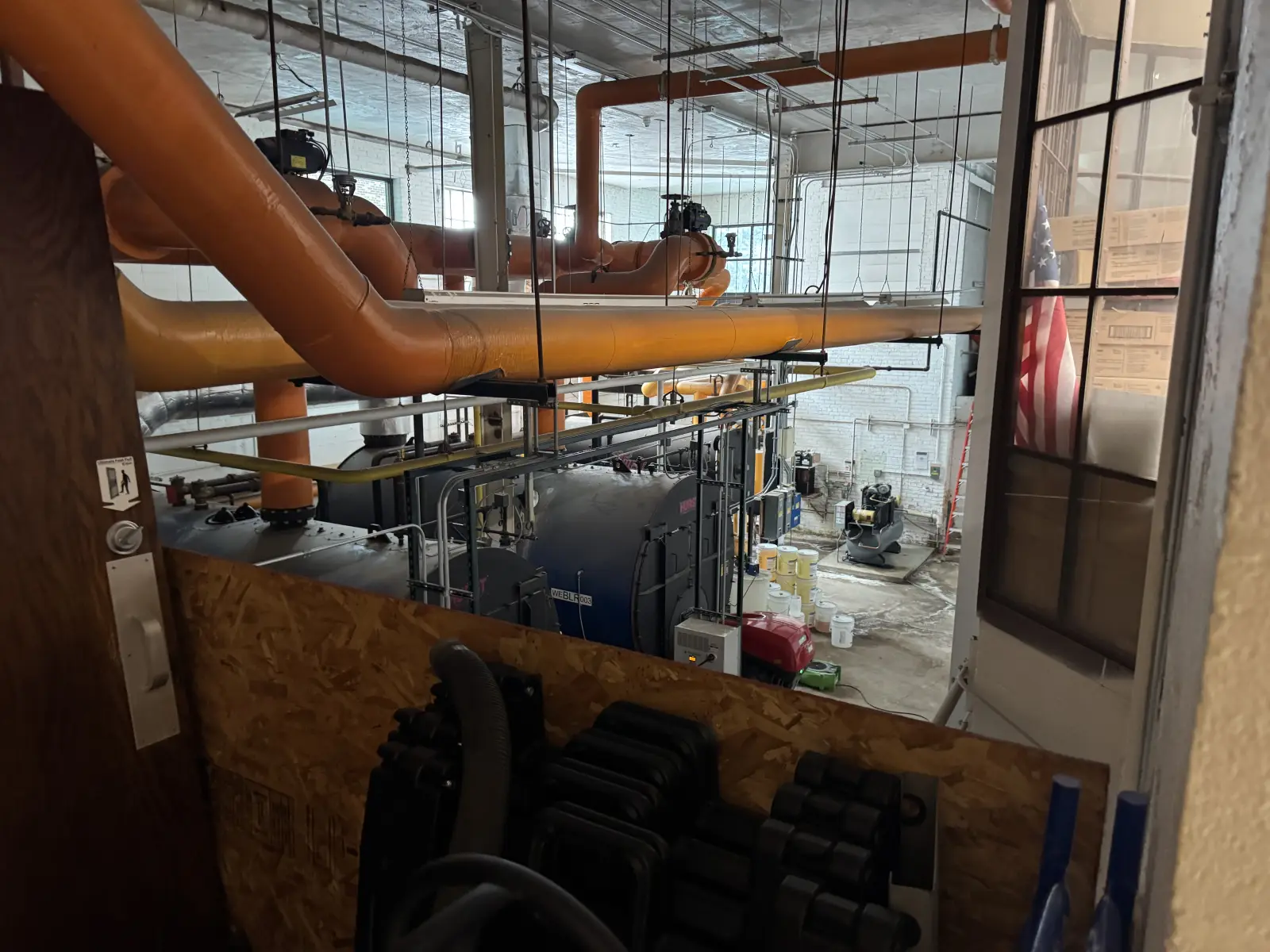Commercial boiler room with insulated hot water piping overhead